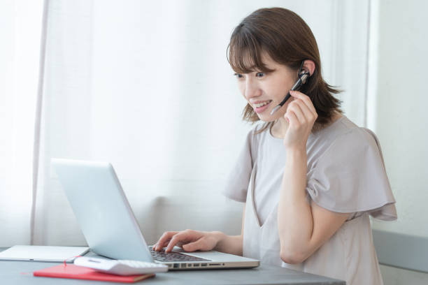 Japanese woman doing desk work at home stock photo