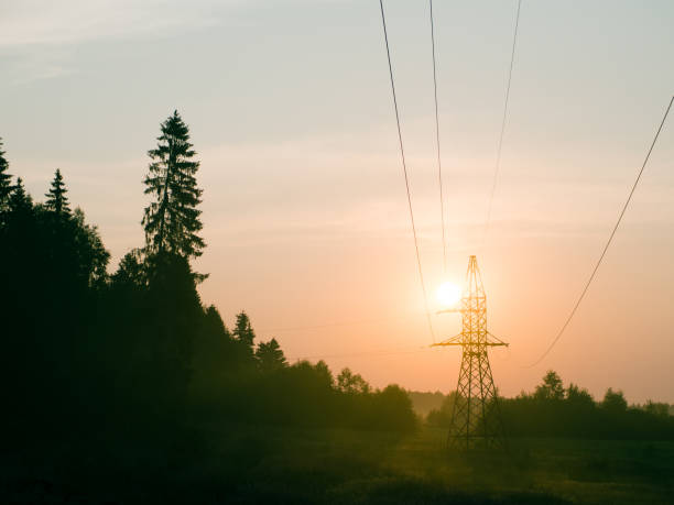 istock orange dawn with high voltage tower wires and nature 1414777824