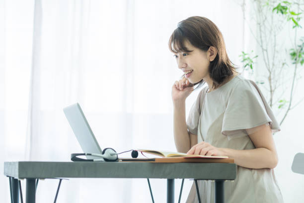 istock Japanese woman doing desk work at home 1414779692