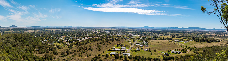 Panoramic view on the town suburb houses situated in picturesque valley surrounded by the hills. Porcupine lookout, Gunnedah, New South Wales, Australia