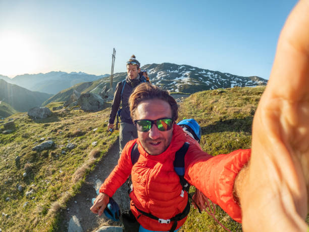 istock Mountaineers walking on trail, selfie 1414780703