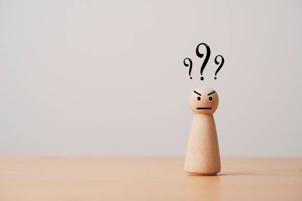 istock Wooden figure standing with question mark for question and answer time concept. 1414780970