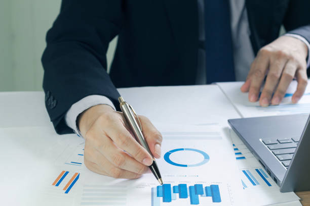 istock Business man analyzing chart and graph showing changes on the market.On the table in the office, the concept of calculating investment results 1414781791