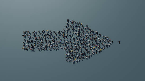 Arrow made of people standing on the ground stock photo