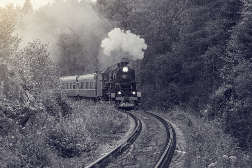 Retro steam train approaches to the station.