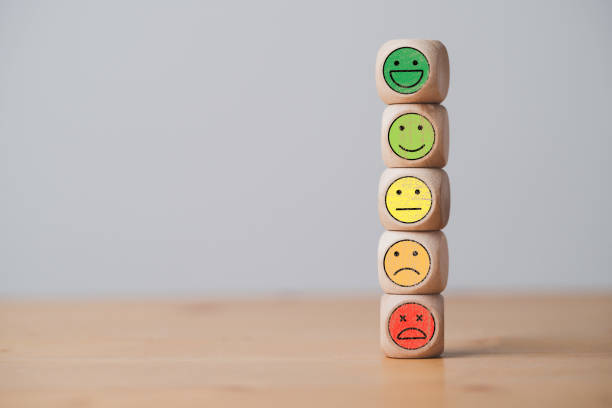 istock Emotion icons stacking on wooden cube block include smile and sad emotion for customer service evaluation concept. 1414786608