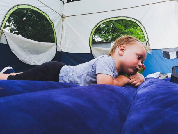 istock Child laying on air mattress inside a tent 1414787940