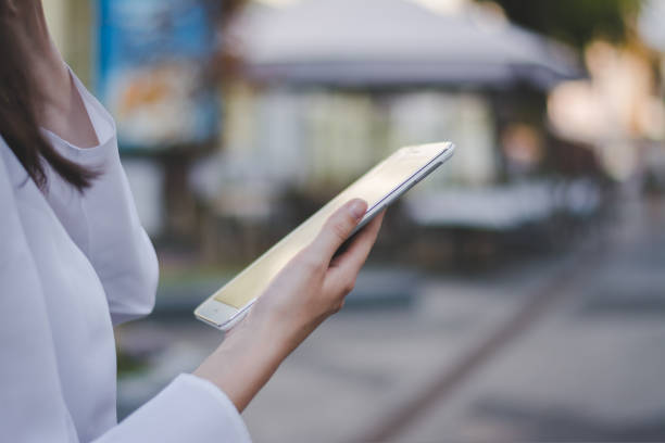 istock woman using a tablet pc outdoors 1414788162