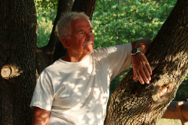istock Thoughtful Senior Adult Leaning On A Tree Trunk 1414788280