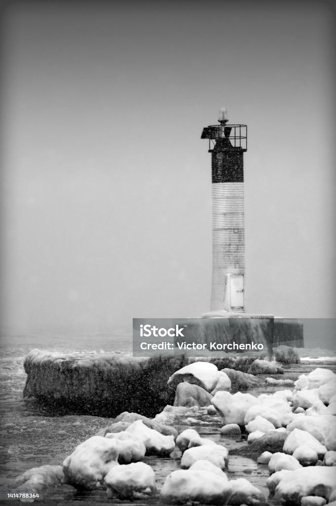 Oakville lighthouse at winter storm on lake Ontario Black And White Stock Photo