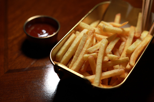Tasty French Fries And Ketchup On Wooden Table