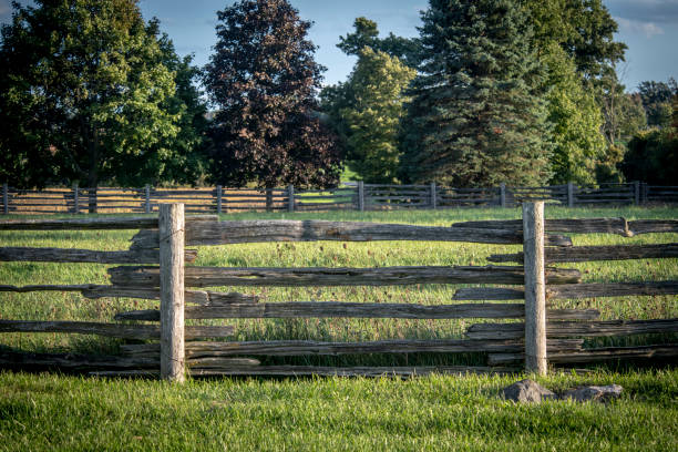 istock Old fence around a rural grass field 1414788540