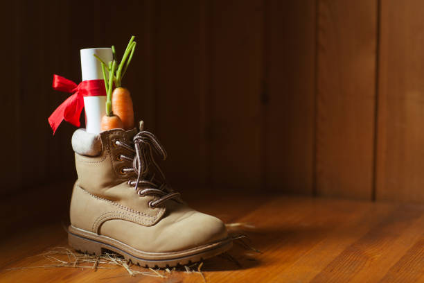 shoe with carrots for amerigo's horse and letter for st. nicholas for traditional dutch holiday sinterklaas or for christmas - sinterklaas stockfoto's en -beelden