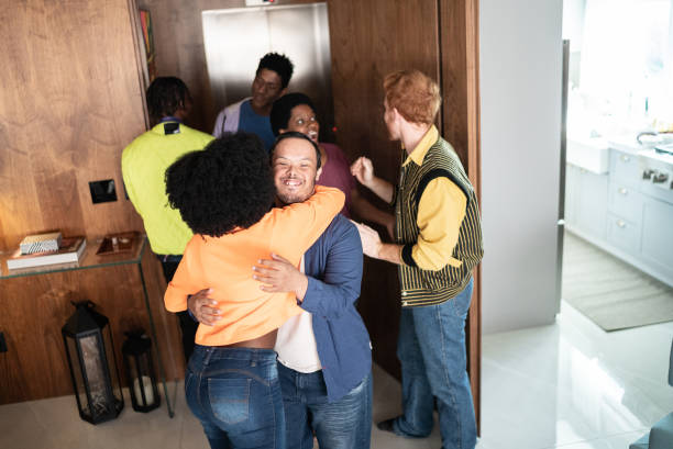 istock Friends arriving and greeting each other at home 1414790762