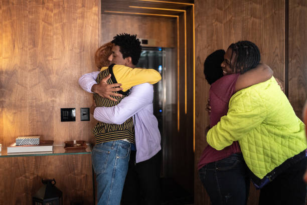 istock Friends arriving and greeting each other at home 1414790772