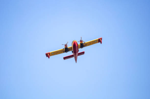 istock Canadair flight, Firefight Aircraft, scooper flying on blue sky, under view. 1414791911