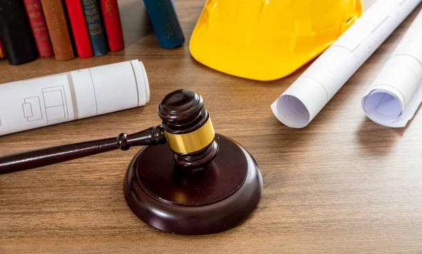 istock Construction and Labor law. Judge gavel and building drawings on table 1414792197