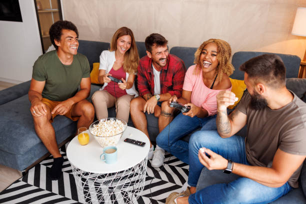 istock Friends having fun playing video games at home 1414792962