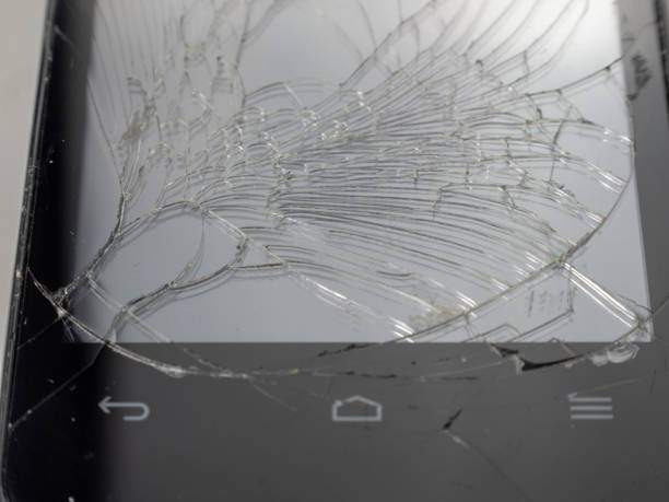 istock Old smartphone. Broken phone. Phone on a gray background. 1414793931