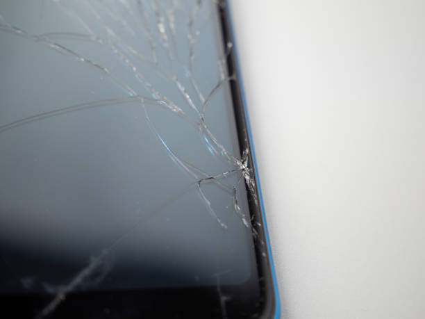 istock Old smartphone. Broken phone. Phone on a gray background. 1414793983
