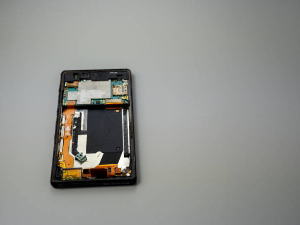 istock Old smartphone. Broken phone. Phone on a gray background. 1414793989