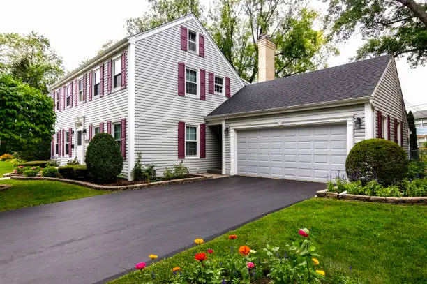 Saltbox colonial house with zinnia garden in foreground