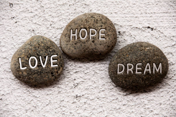 istock Love, hope and dream engraved on stones. Life concept 1414797420