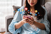 Young woman with drinks using mobile phone and relaxing at home, Modern lifestyle and social media concept.