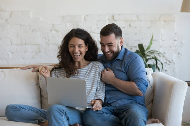 istock Excited millennial married couple looking at laptop computer screen 1414798662