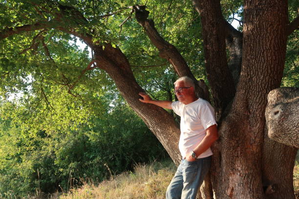 istock Thoughtful Senior Adult Leaning On A Tree Trunk 1414798874