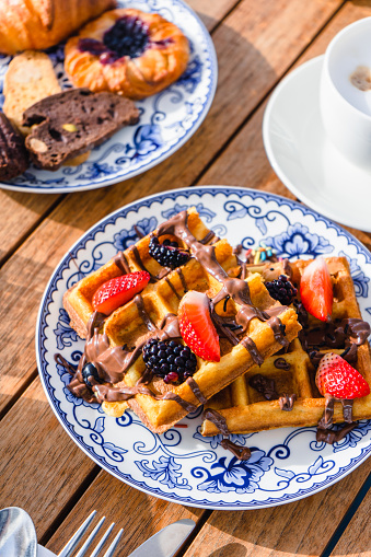 Belgian waffles served with fresh berries and chocolate sauce