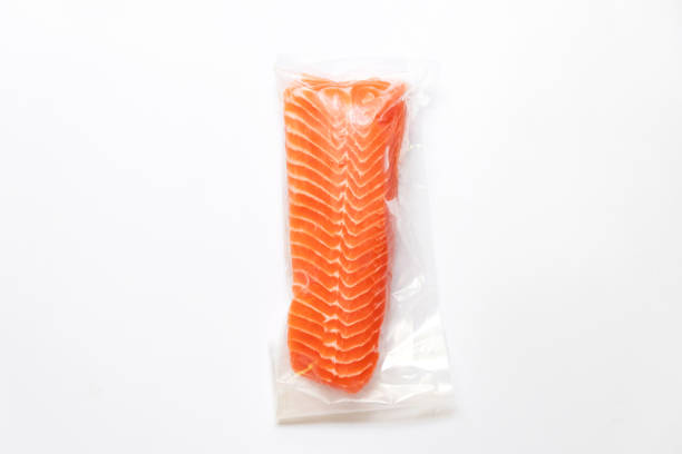 Fresh salmon fillet in vacuum package isolated on white background for delicious salmon steak. Fresh salmon fillet in vacuum package isolated on white background for delicious salmon steak. vacuum packed stock pictures, royalty-free photos & images