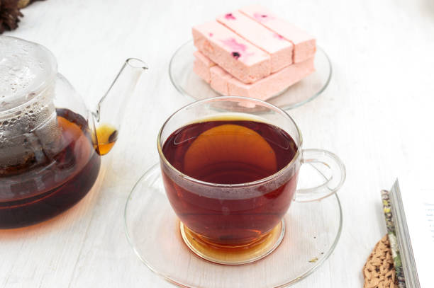 istock Pink fruit marshmallow with cranberries, teapot and cup of black tea 1414801287