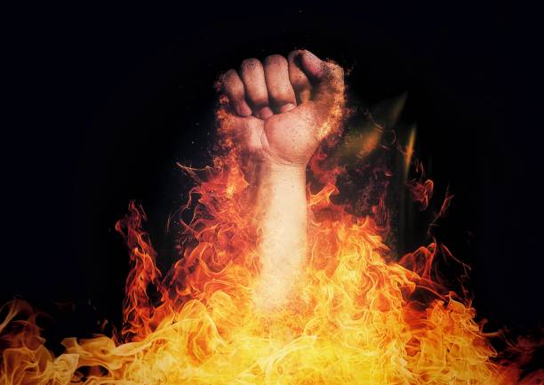 istock 3D illustration of a fist breaking through flames 1414801514