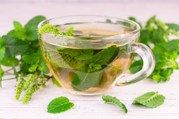 istock Cup with mint tea on a white wooden background.Close-up. 1414802543