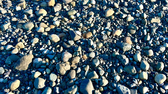 the rocky beach of the Pacific ocean showing each stone for any background For the text of the advertisement music for relaxation Parksville beach Surfside RV resort.
