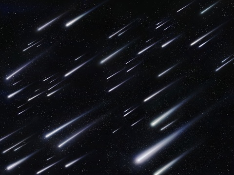 Meteor shower in the night sky against the background of stars. Meteorites burn in the atmosphere. Beautiful falling stars.