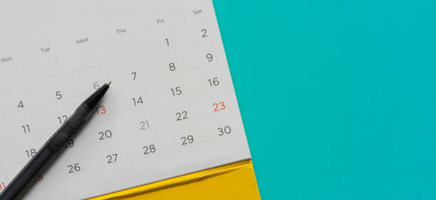 istock close up top view on white calendar schedule to make appointment meeting or manage timetable each day lay on teal background for planning work and life concept 1414806638