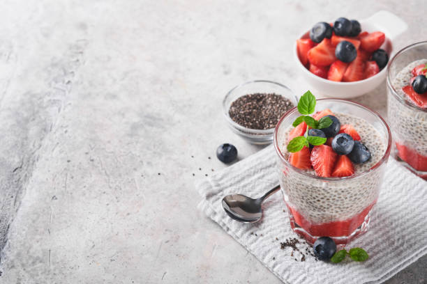 istock Chia strawberry pudding. Healthy vegan breakfast chia seeds pudding with fresh berries and mint in glass on gray concrete background. Concept of healthy eating, dieting, fitness menu. Selective focus. 1414806639