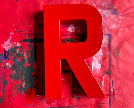 Papier-mâché R with red paint