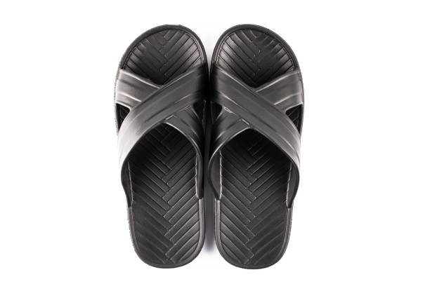 istock Rubber black slippers on a white background. Black universal slippers. 1414807998