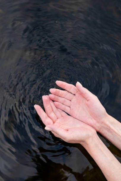 istock girl touch water, closeup view 1414808018