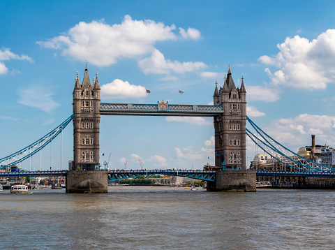 A view of Tower Bridge seen from the middle of the River Thames in London, England. Facing downstream, the South Bank is on the right of the image.