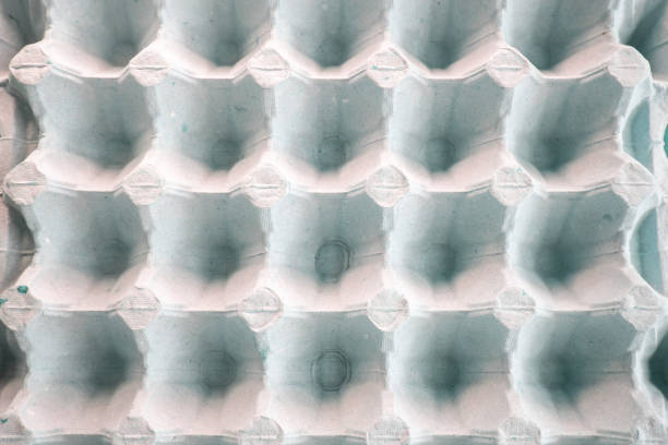 istock Top view of an empty cardboard egg tray. Background texture of a container made of biodegradable paper packaging with a repeating pattern 1414809930