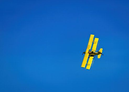 Complimentary colors with Yellow Crop Duster and deep blue sky