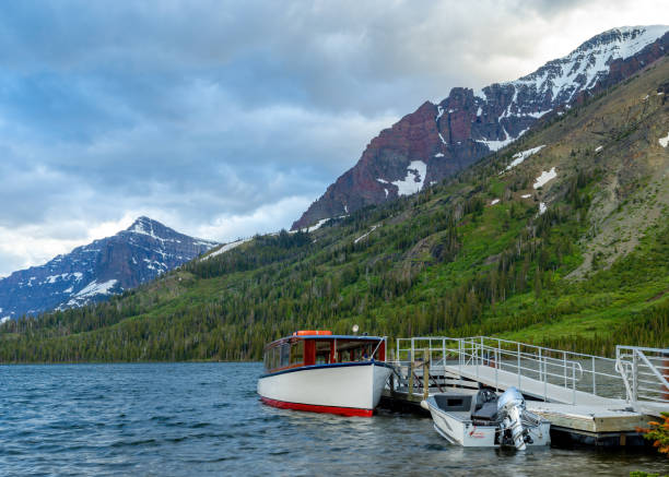 istock Mountain lake with boats attached to a dock 1414810001