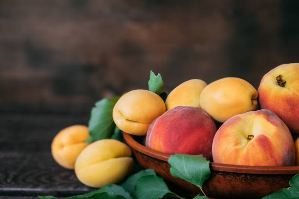 istock Apricots and peaches in one bowl 1414810693