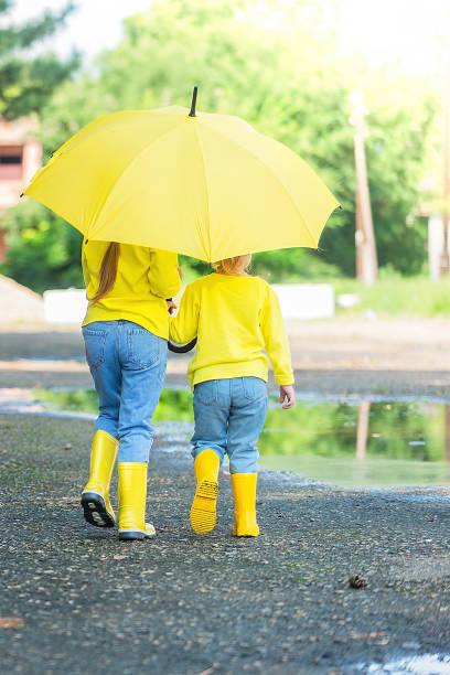 istock children have fun after the rain, run through the puddles 1414811061