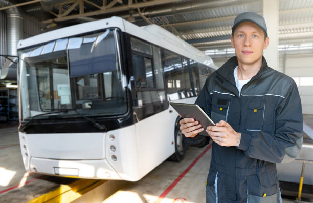 Serviceman with digital tablet on the background of the bus stock photo