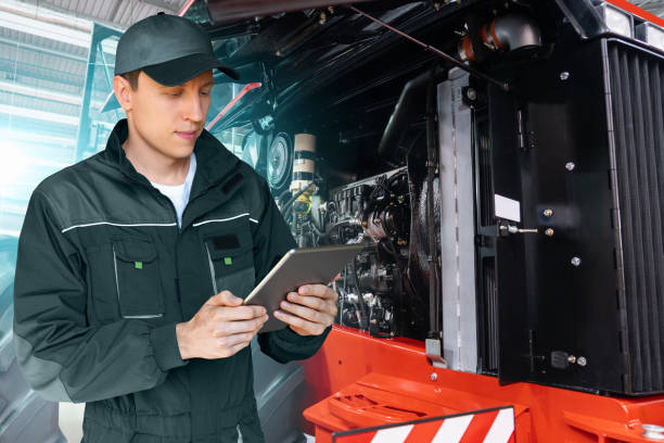 istock Serviceman with digital tablet on a background of the tractor 1414811125
